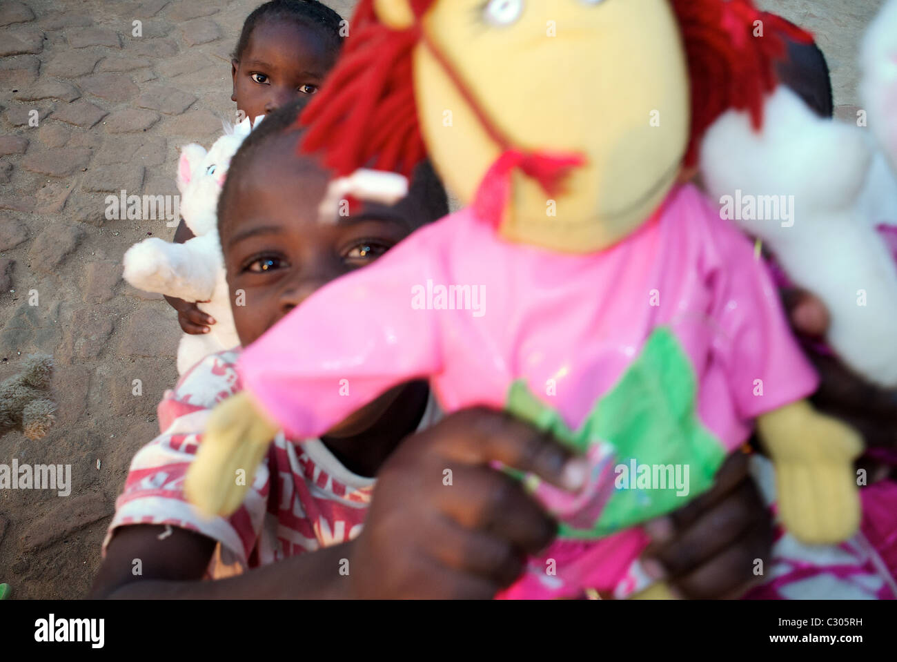 African orphans with toys . Mahenge Tanzania. Stock Photo