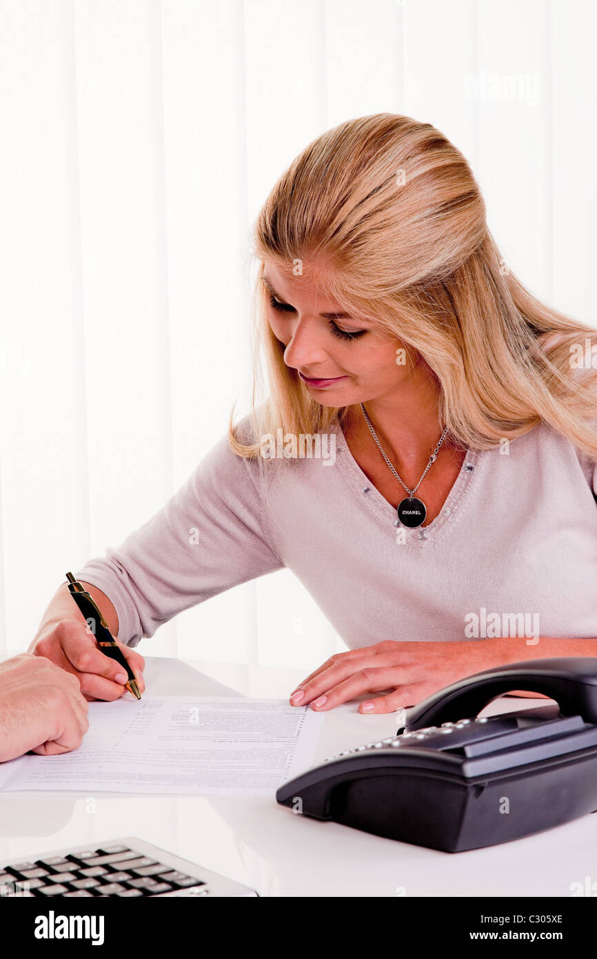 woman signs contract Stock Photo