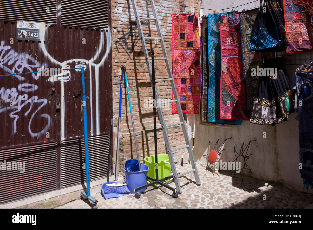 Cleaning materials and Moorish clothing styles in a street corner of the Arabic Albaicon quarter. Stock Photo