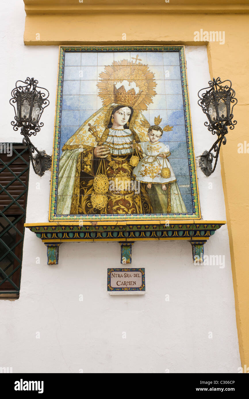 Andalucian ceramic tiling of the Virgin Mary on a church wall in Seville. Stock Photo