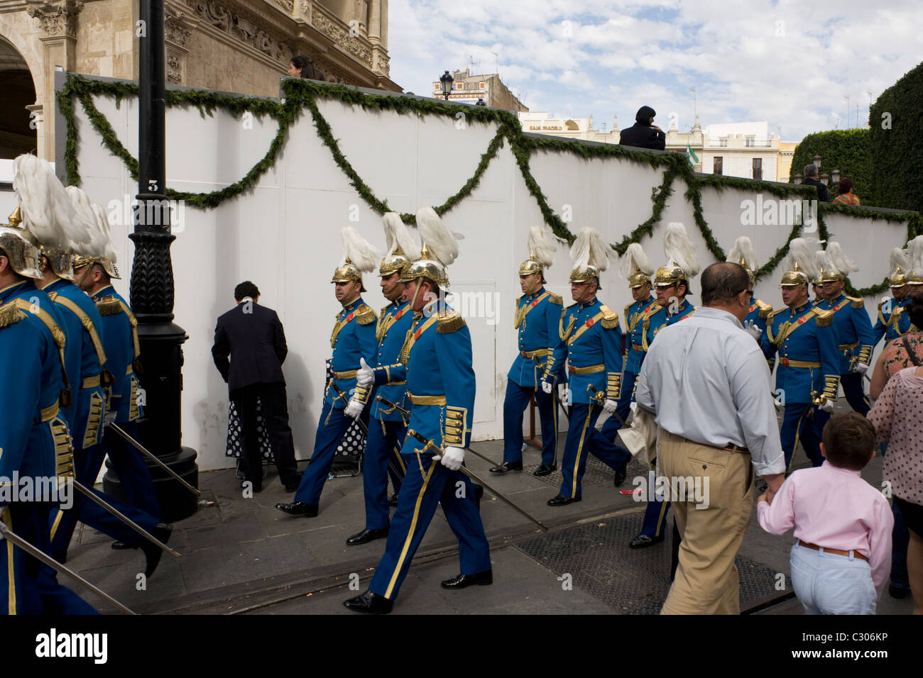 Uniformed musicians march through the city of Seville after religios Easter parades during Semana Santa. Stock Photo