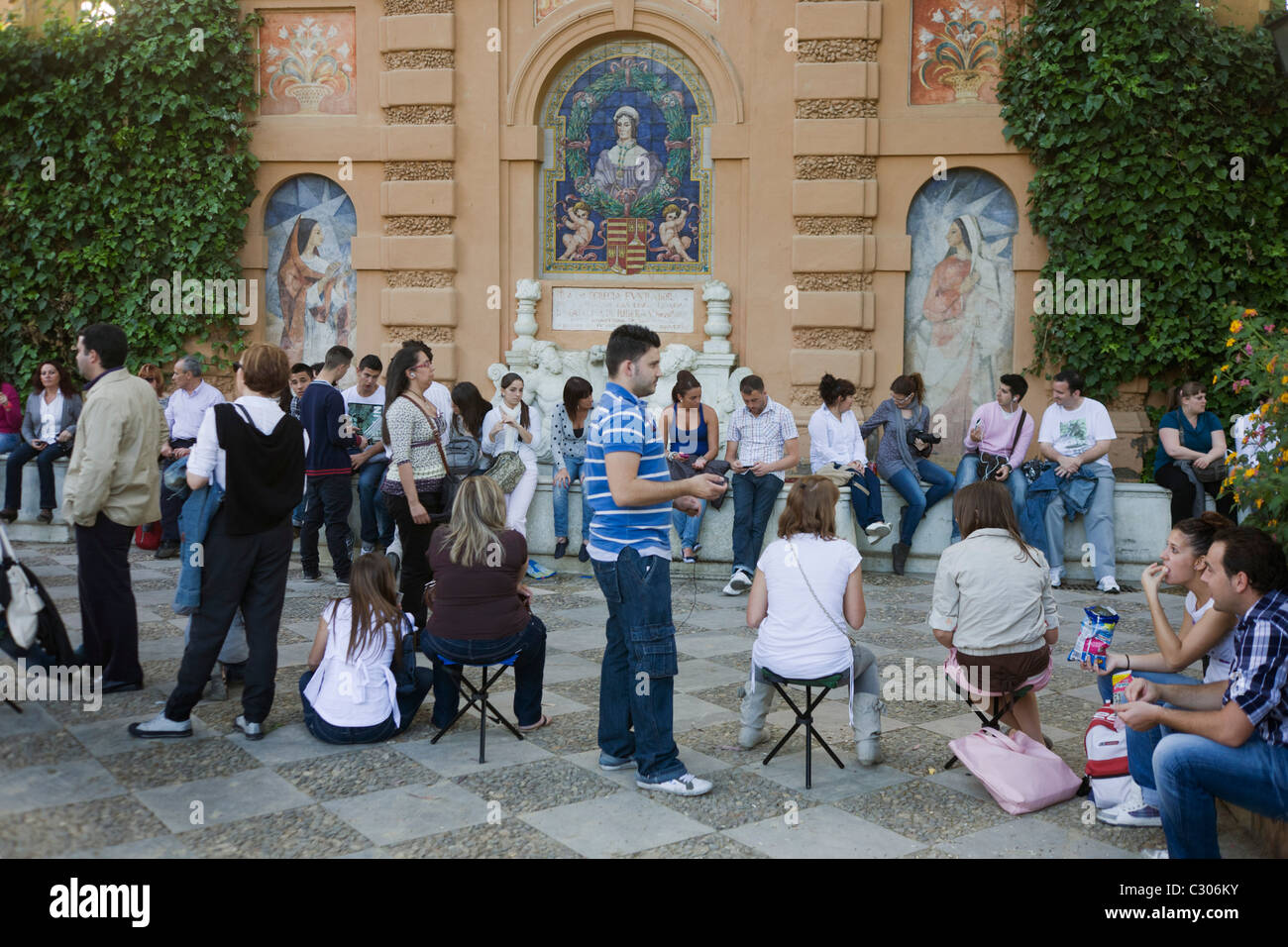 Devout Spaniards await an Easter procession in Jardines de Murillo during Semana Santa. Stock Photo
