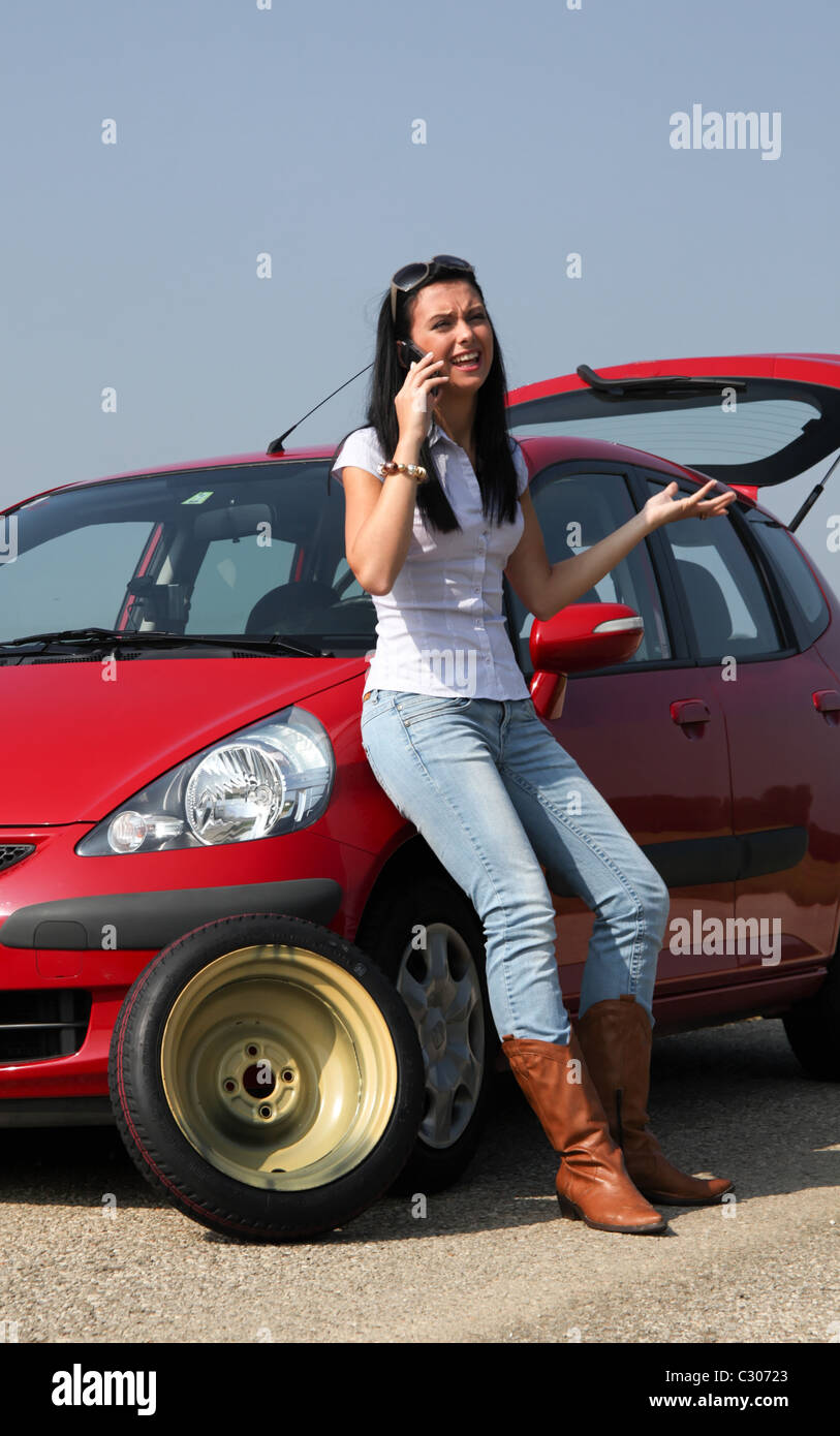 Woman with a flat tire in car Stock Photo Alamy