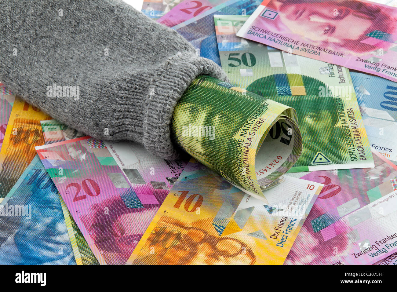 Saving socks with swiss money Stock Photo