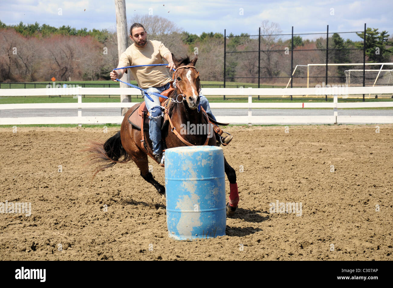 Young man barrel racing Stock Photo - Alamy
