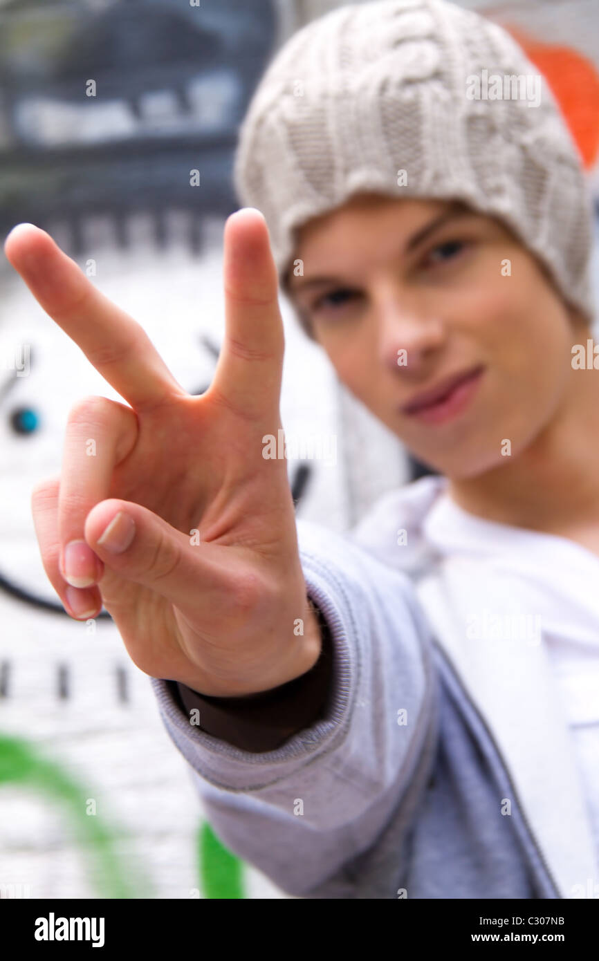 Cool-looking young man in front of graffiti Stock Photo