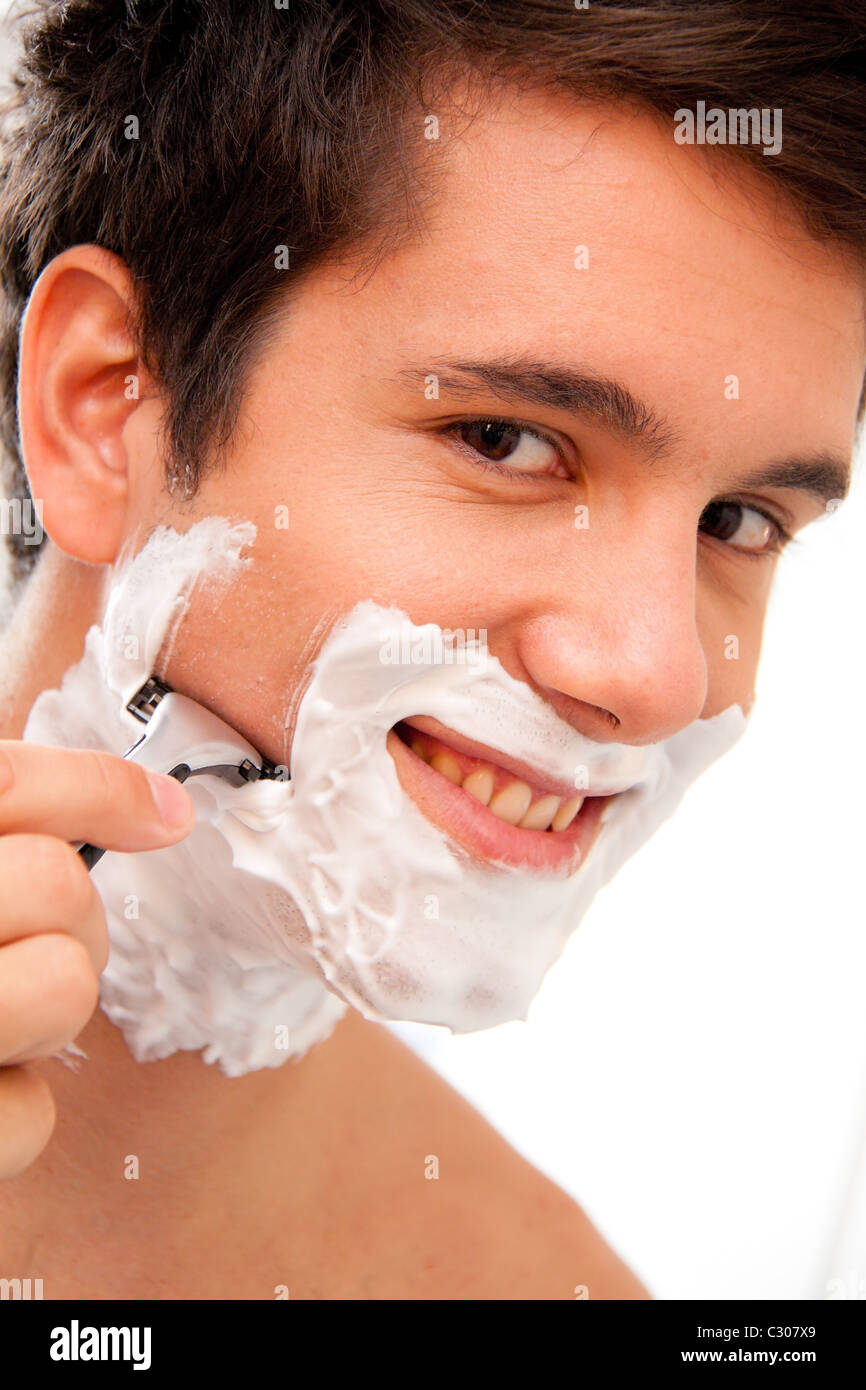 Man shaves with a razor and shaving cream Stock Photo