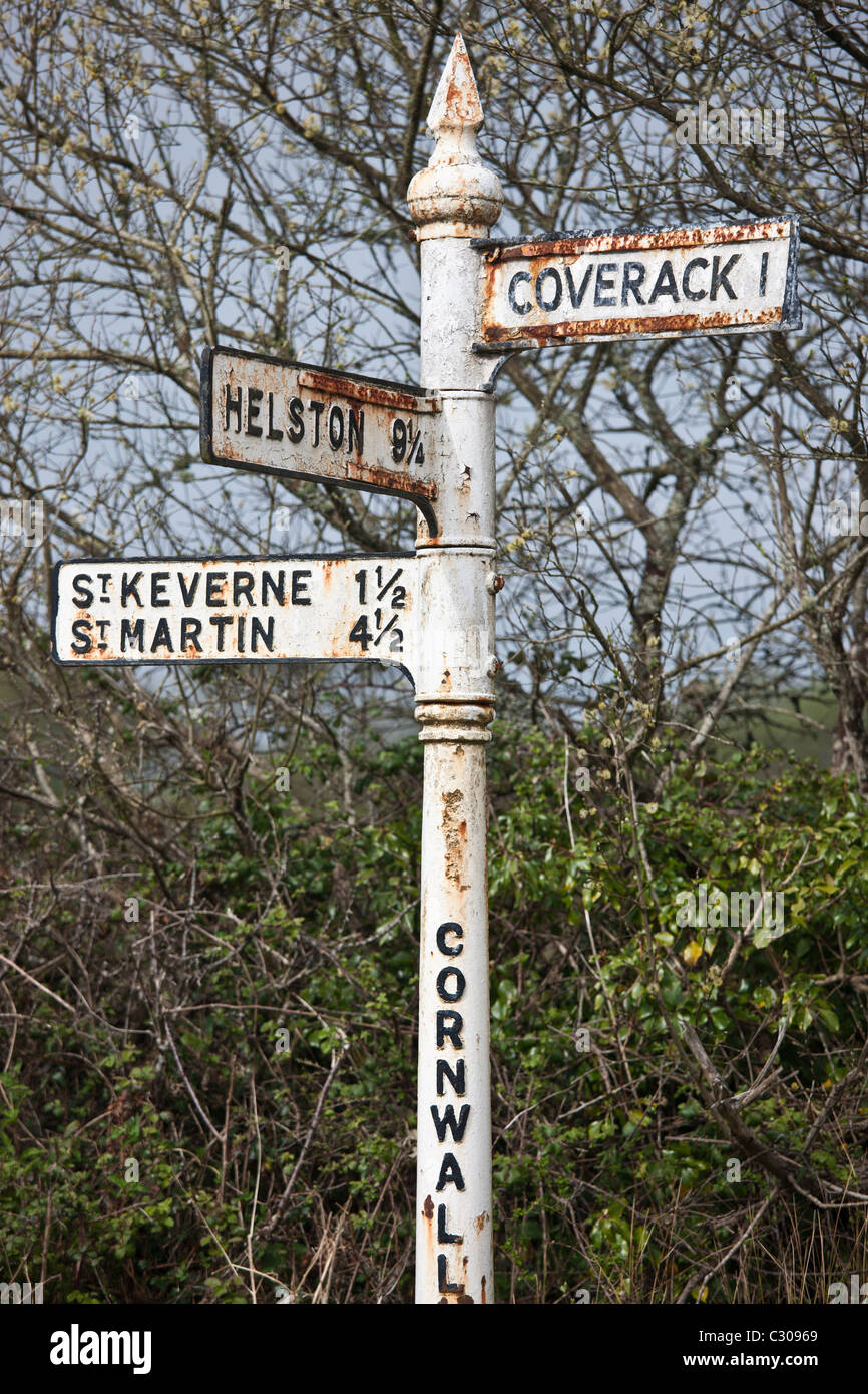 Quaint old rusty signpost to tourist attractions Coverack, Helston, St Keverne and St Martin in Cornwall, England, UK Stock Photo