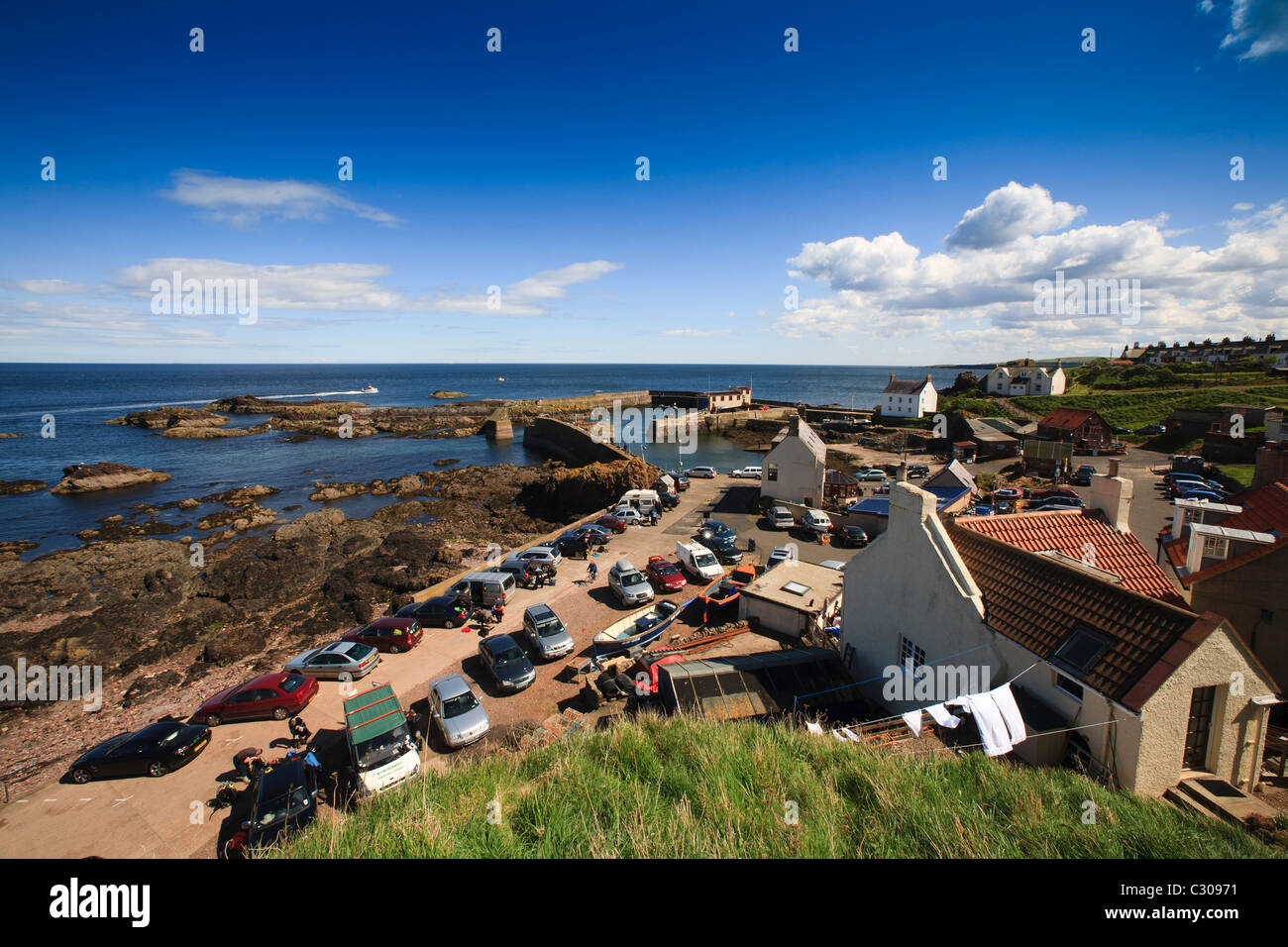 Divers ready themselves in the carpark at St.Abbs harbour. Stock Photo
