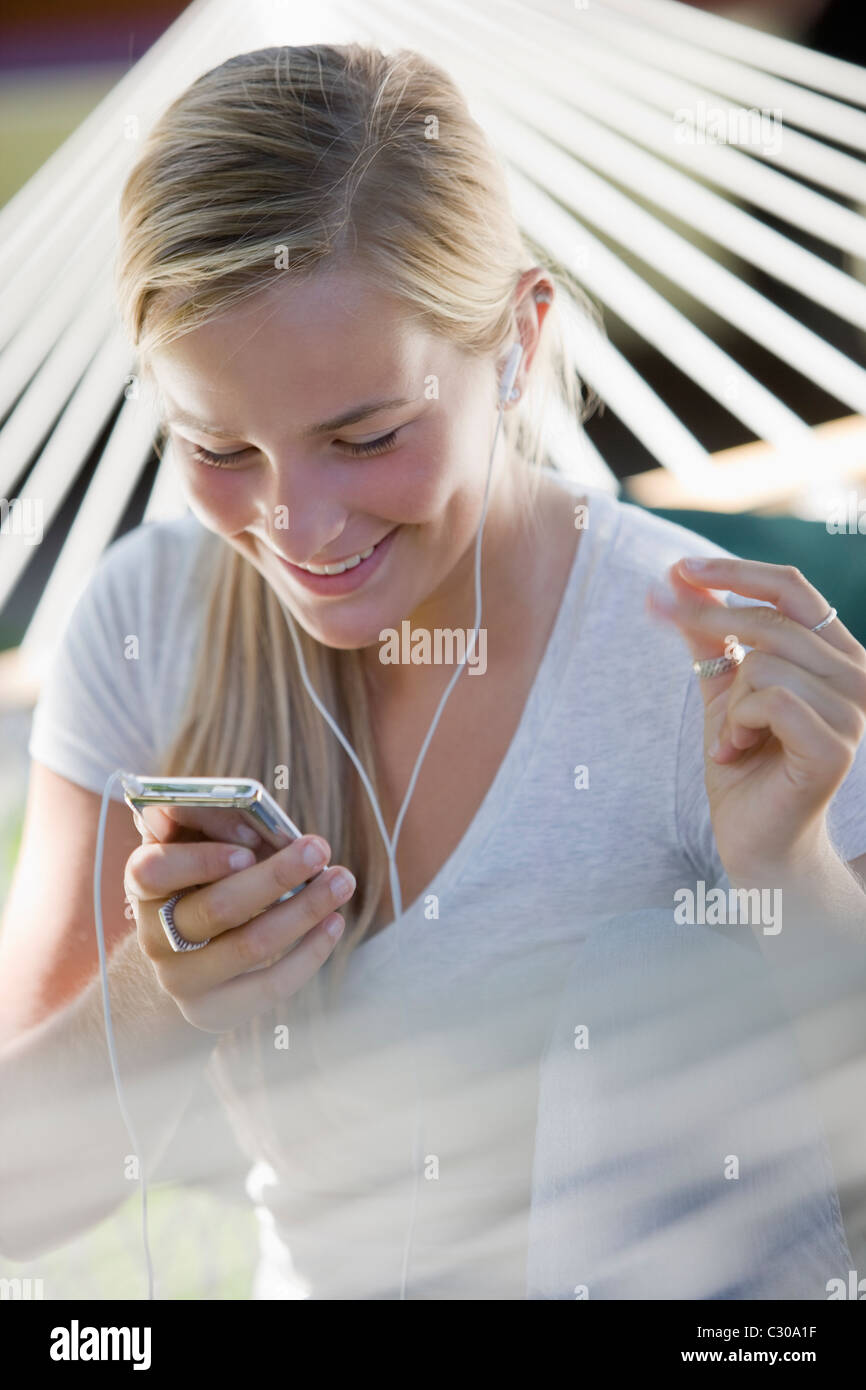 Happy teenager grooving to the music on her MP3 player Stock Photo Alamy
