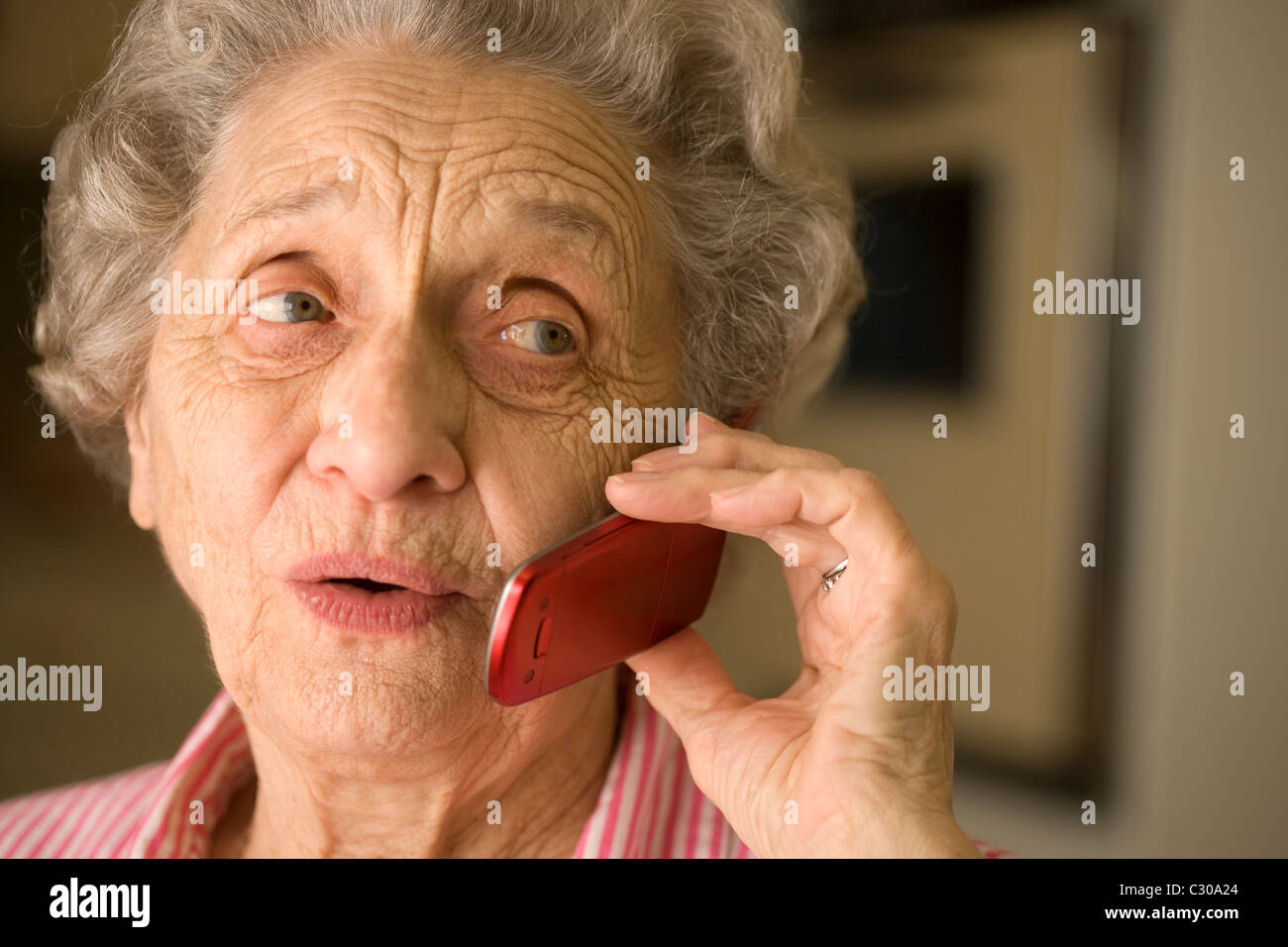 Smiling elderly woman talking on cell phone Stock Photo