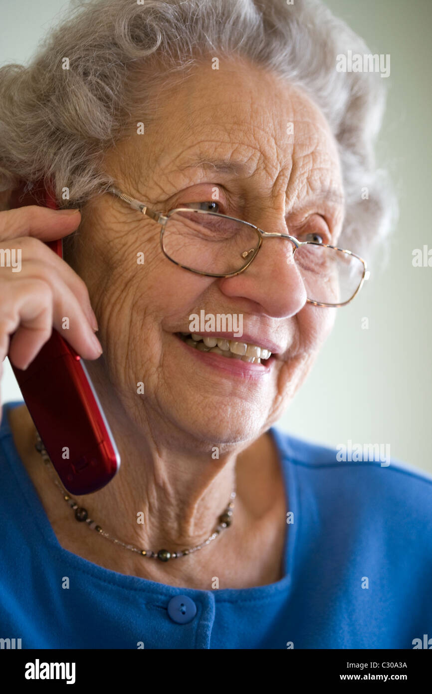 Smiling elderly woman talking on cell phone Stock Photo