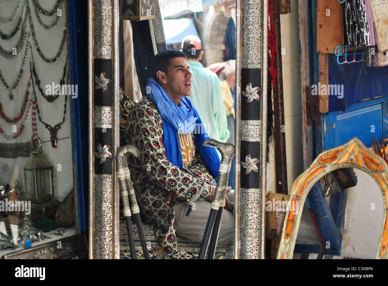 Shopkeeper reflected in mirror, Essaouira, Morocco Stock Photo