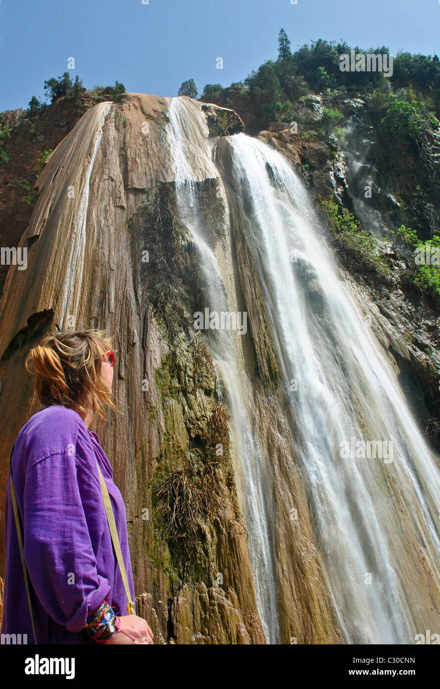 Tourist admiring the waterfall at Immouzzer, Morocco Stock Photo