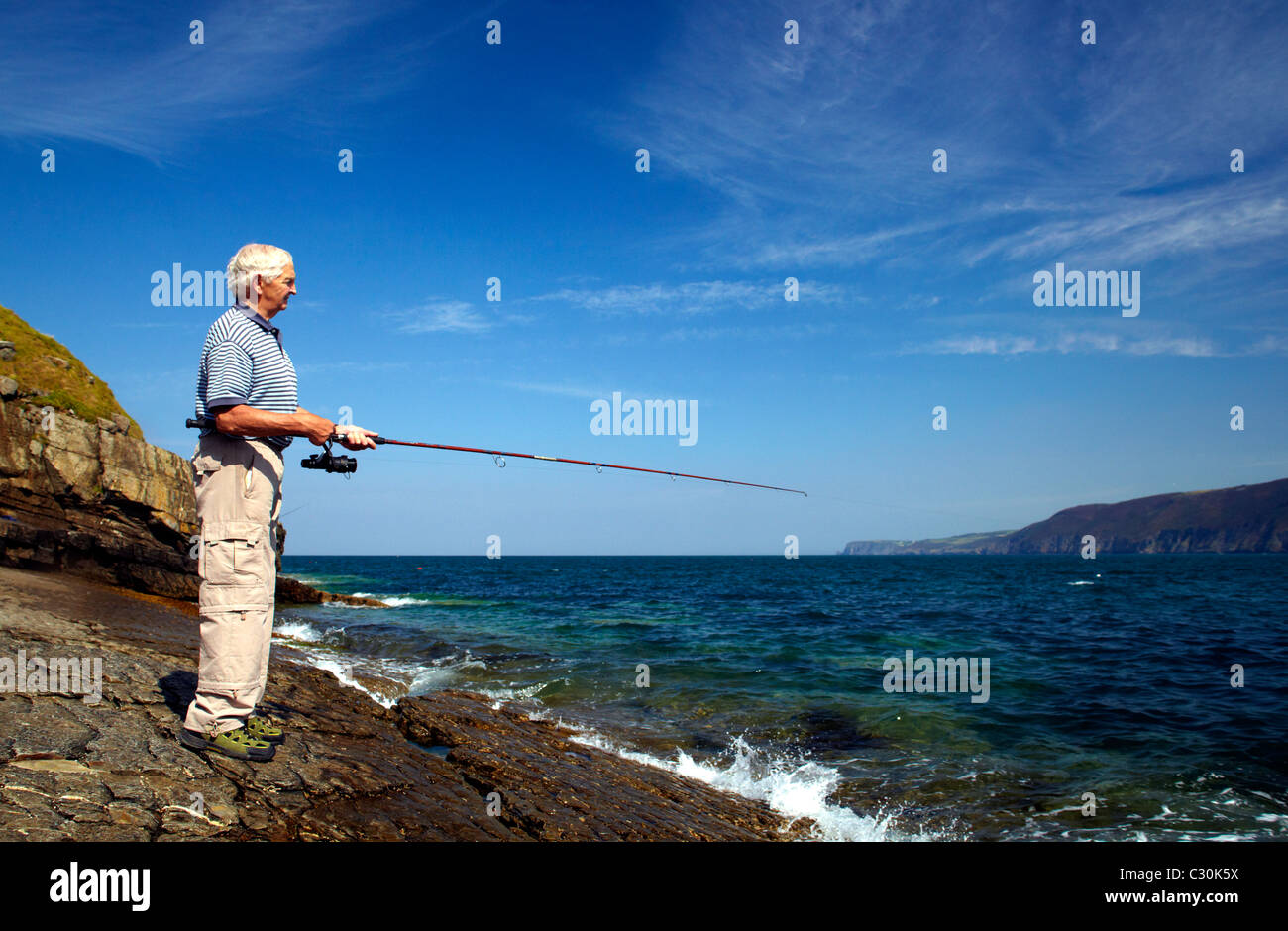 Angler spinning for Mackerel, Pollack and Bass on Ynys Lochtyn