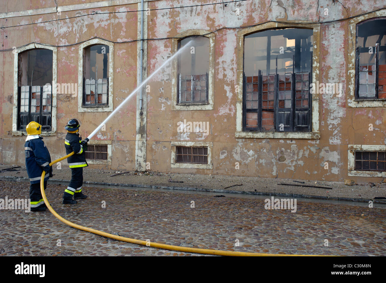 Firemen fighting urban fire Stock Photo Alamy