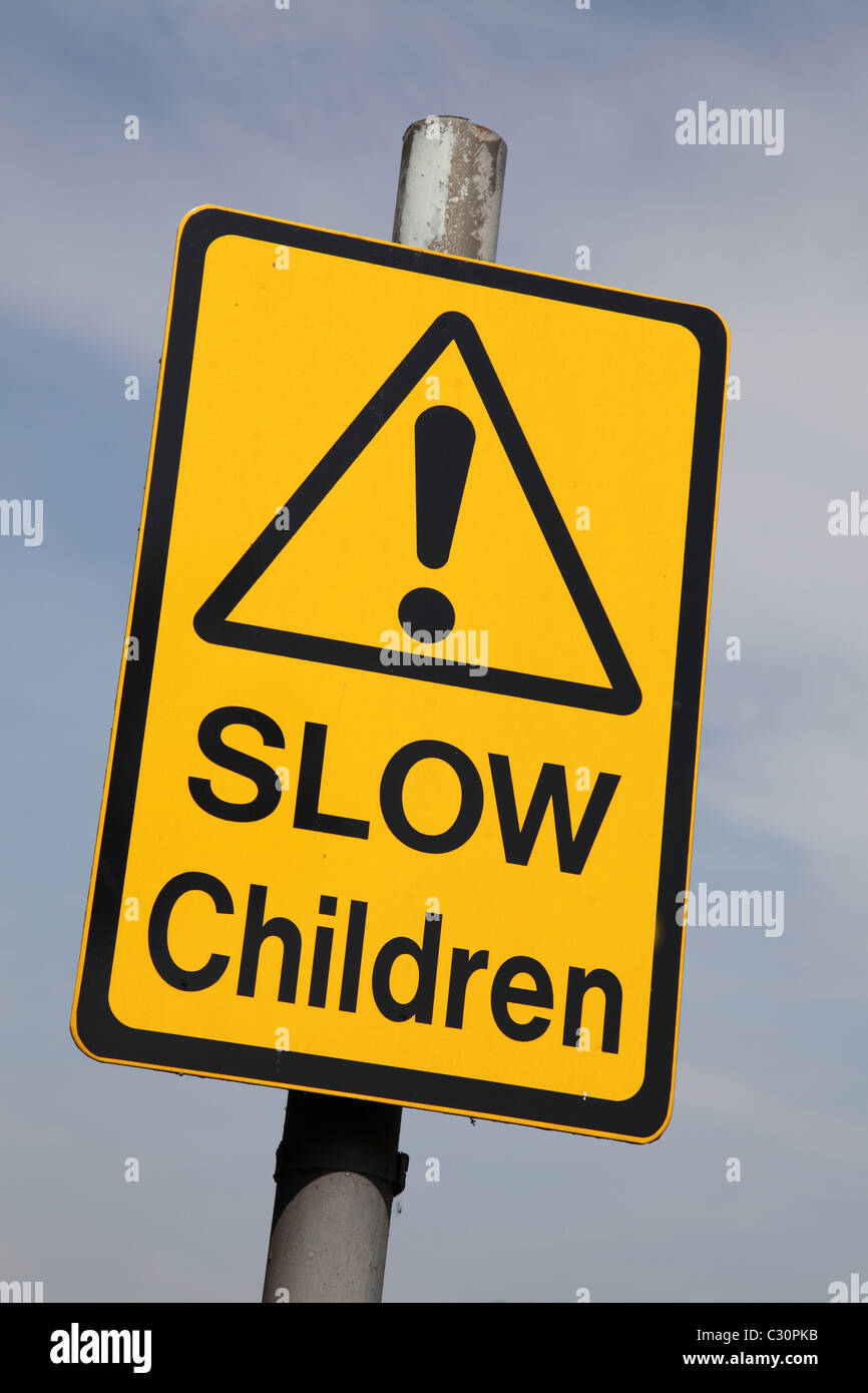 A roadside speed restriction warning sign outside a school in the U.K. Stock Photo