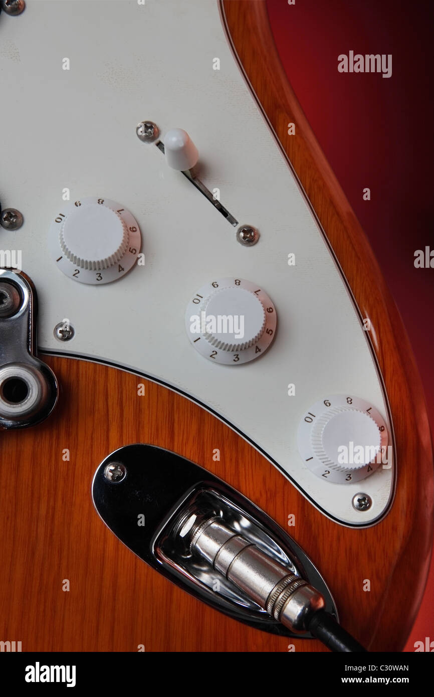 crop on electric guitar mask and controls. Blank rotary buttons could be used as copy space. Stock Photo