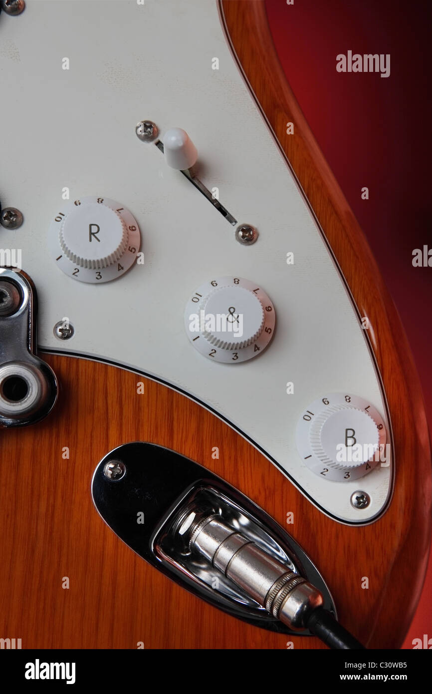crop on electric guitar mask and controls. On the the rotary buttons we can read 'R & B'. Stock Photo