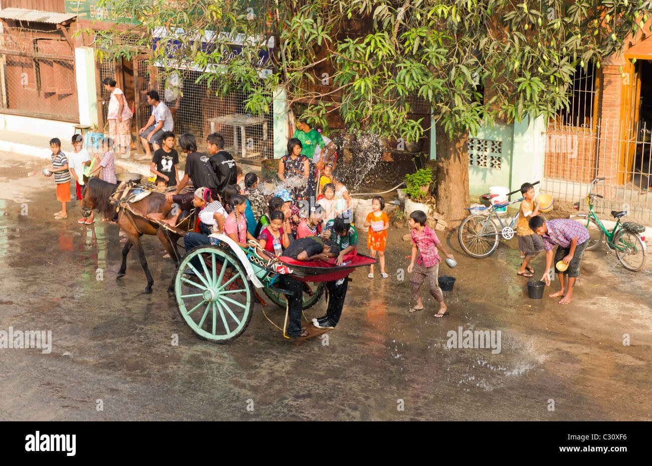 People on Horse Carriage Getting Doused With Water at Thingyan, the Water Festival in Mandalay, Myanmar Stock Photo