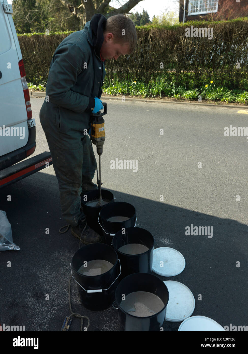 Man Mixing Epoxy Resin (Polyepoxide) Used To Protect Electrical