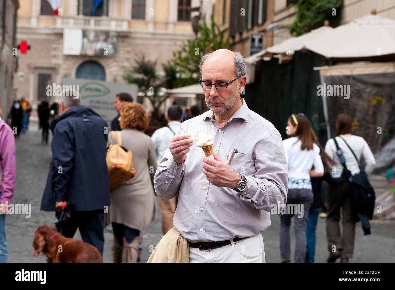 Rome, Italy -April 22, 2011 - A mature man eating ice cream . Stock Photo