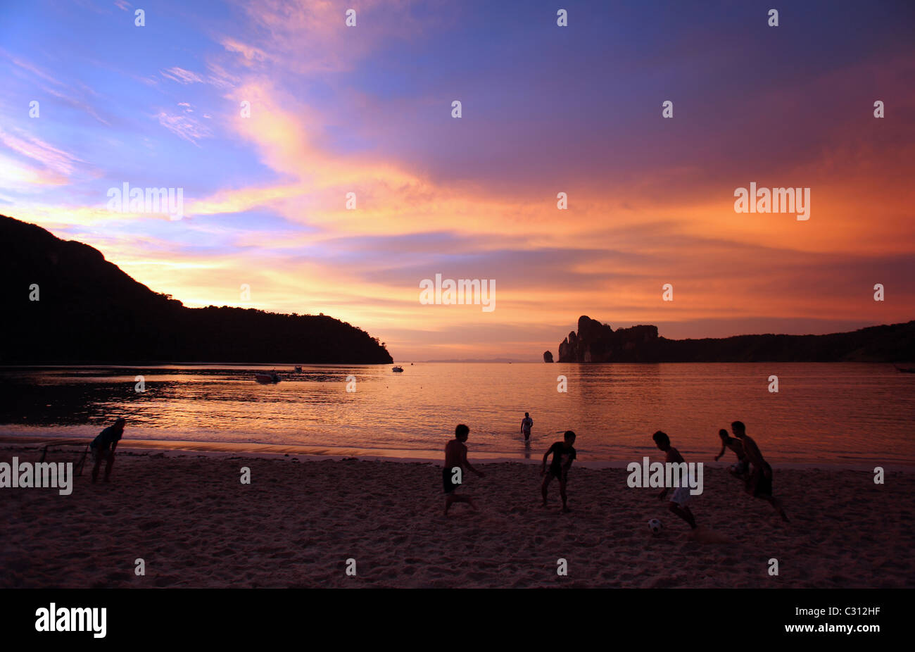 Beach soccer at sunset on Ao Loh Dalam. Ko Phiphi Don, Krabi, Thailand, South-East Asia, Asia Stock Photo