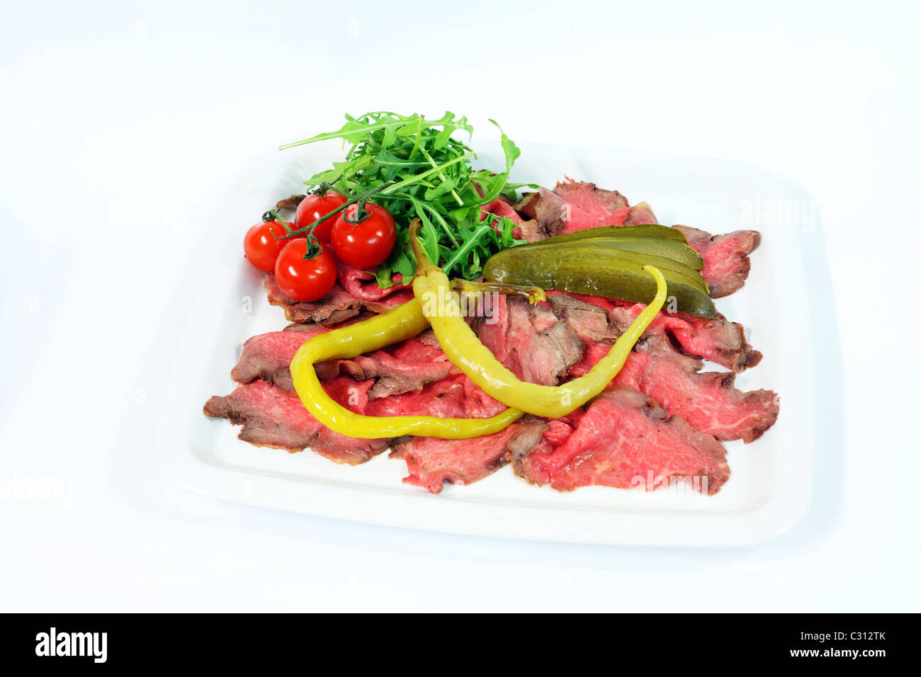 Roastbeef with gherkin and hot pepper on white background Stock Photo ...