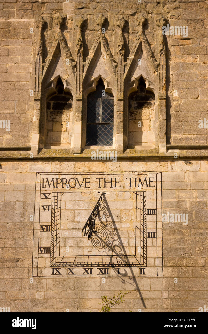 Sunlit sundial with shadow on the stone tower of St. Dionysius Church, Market Harborough, Leicestershire, England, UK Stock Photo