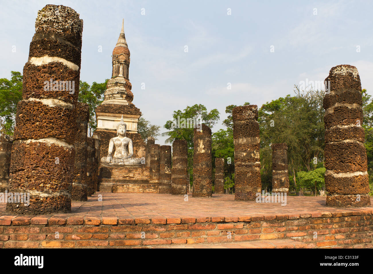 Seated Buddha Statue at Wat Sa Si, Part of the Temple Ruins at Sukothai Historical Park in Thailand Stock Photo