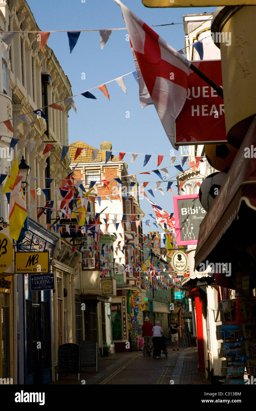 Bunting flags cross narrow alleyway street Weymouth Dorset England Stock Photo