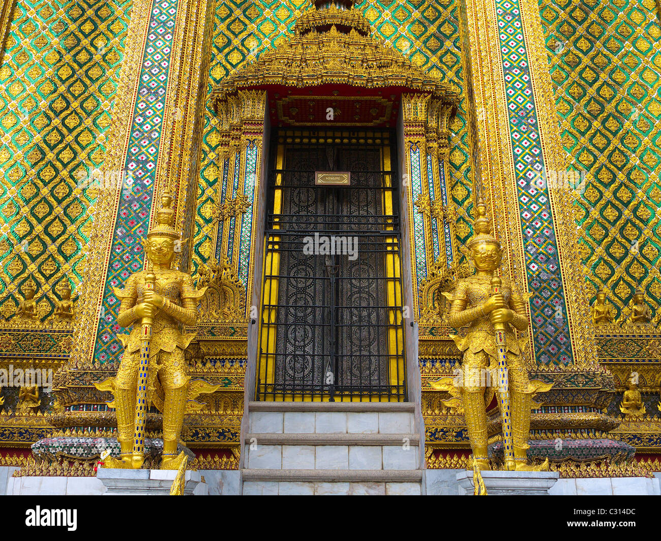 Statues guarding at the Temple of the Emerald Buddha, Bangkok, Thailand Stock Photo