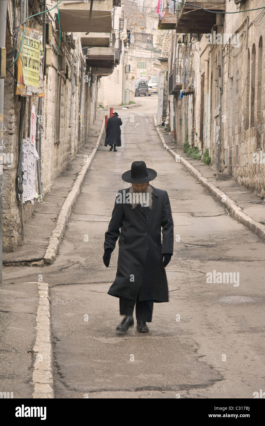 Orthodox jews walking in the Mea Sharim area of Jerusalem, Israel Stock Photo