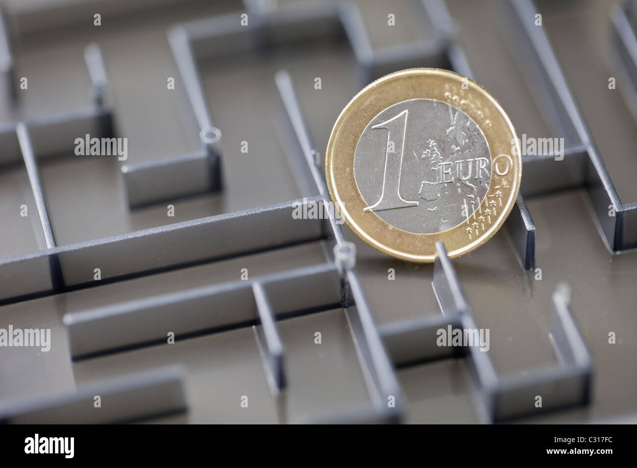 Euro coin in a maze Stock Photo