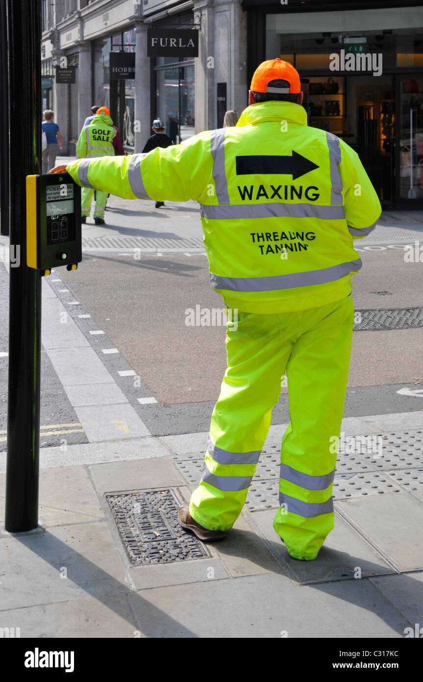 Men wearing high visibility clothes in Regent Street West End London England UK in answer to ban on Sandwich boards see Alamy additional info panel Stock Photo