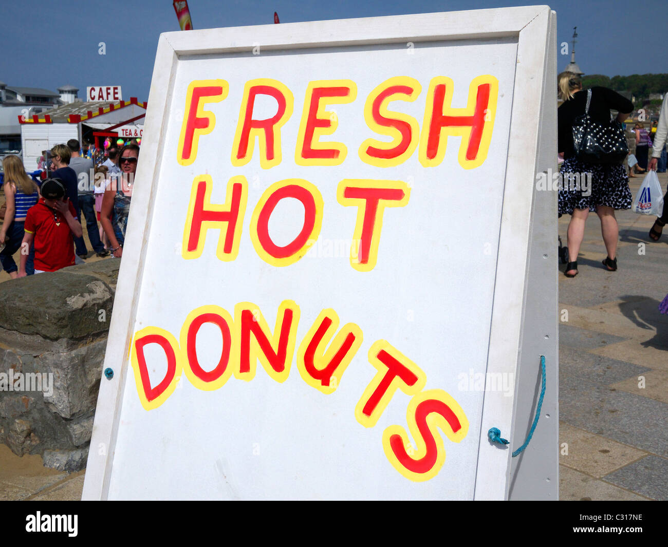 Fresh hot donuts sign at the beach front Weston-Super-Mare North Somerset UK Stock Photo