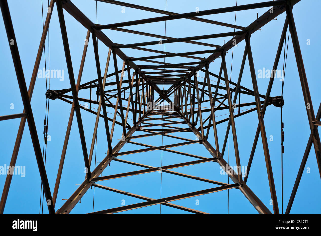 Electricity pylon against blue sky Stock Photo - Alamy