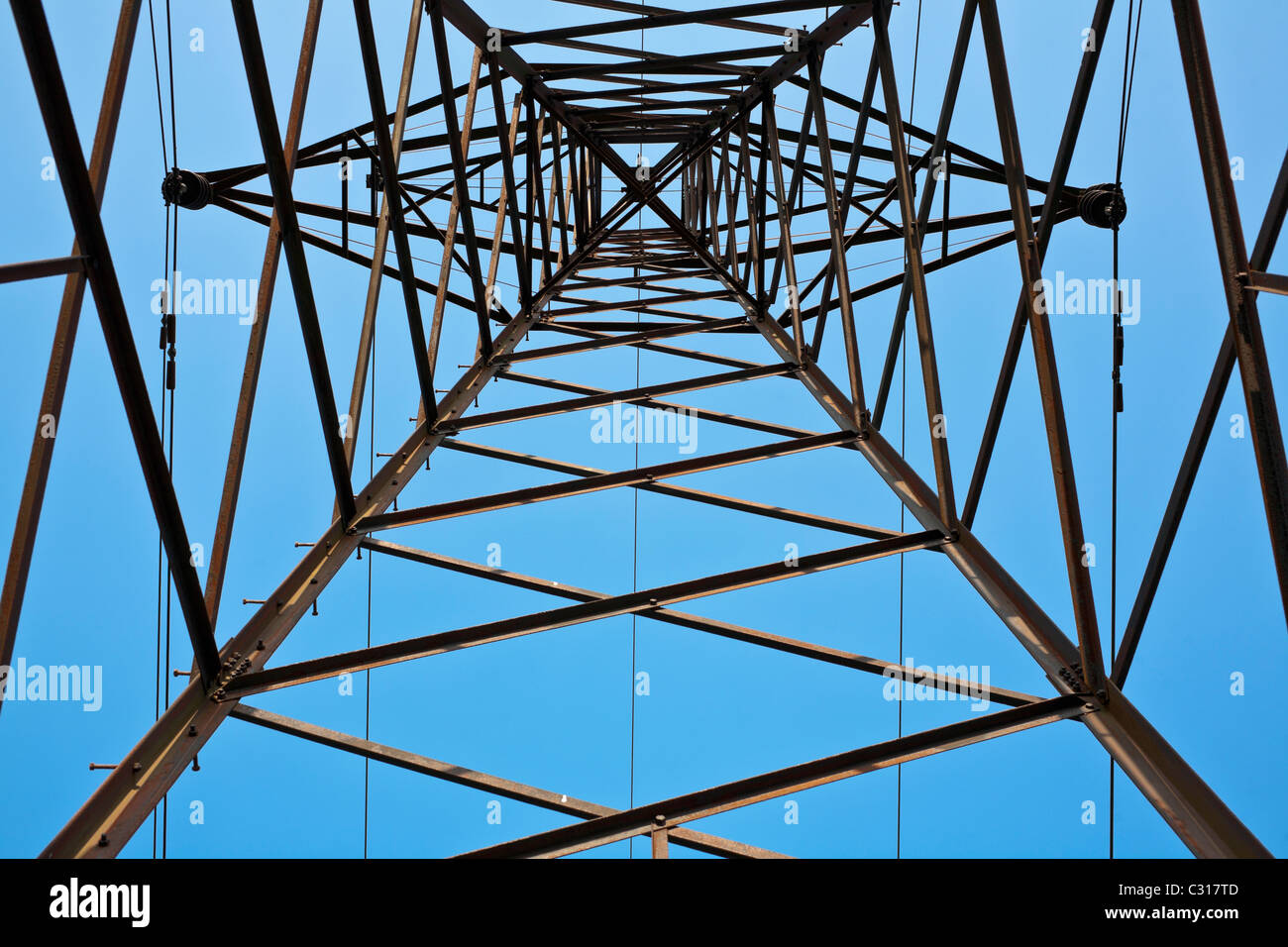 Electricity pylon against blue sky Stock Photo - Alamy