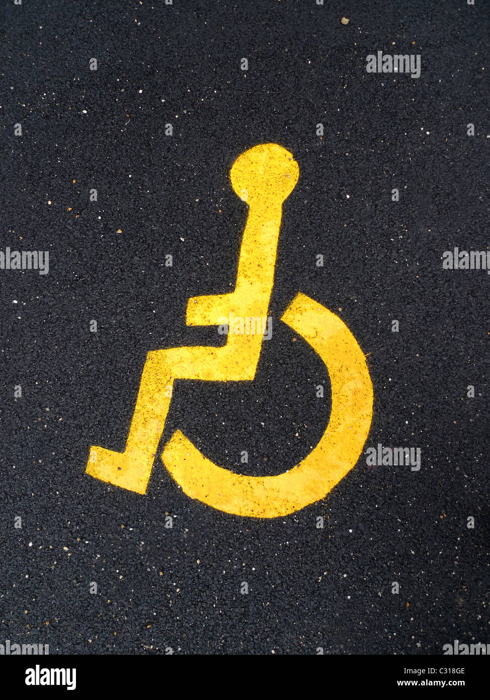Asphalt road with  yellow disable man logo Stock Photo