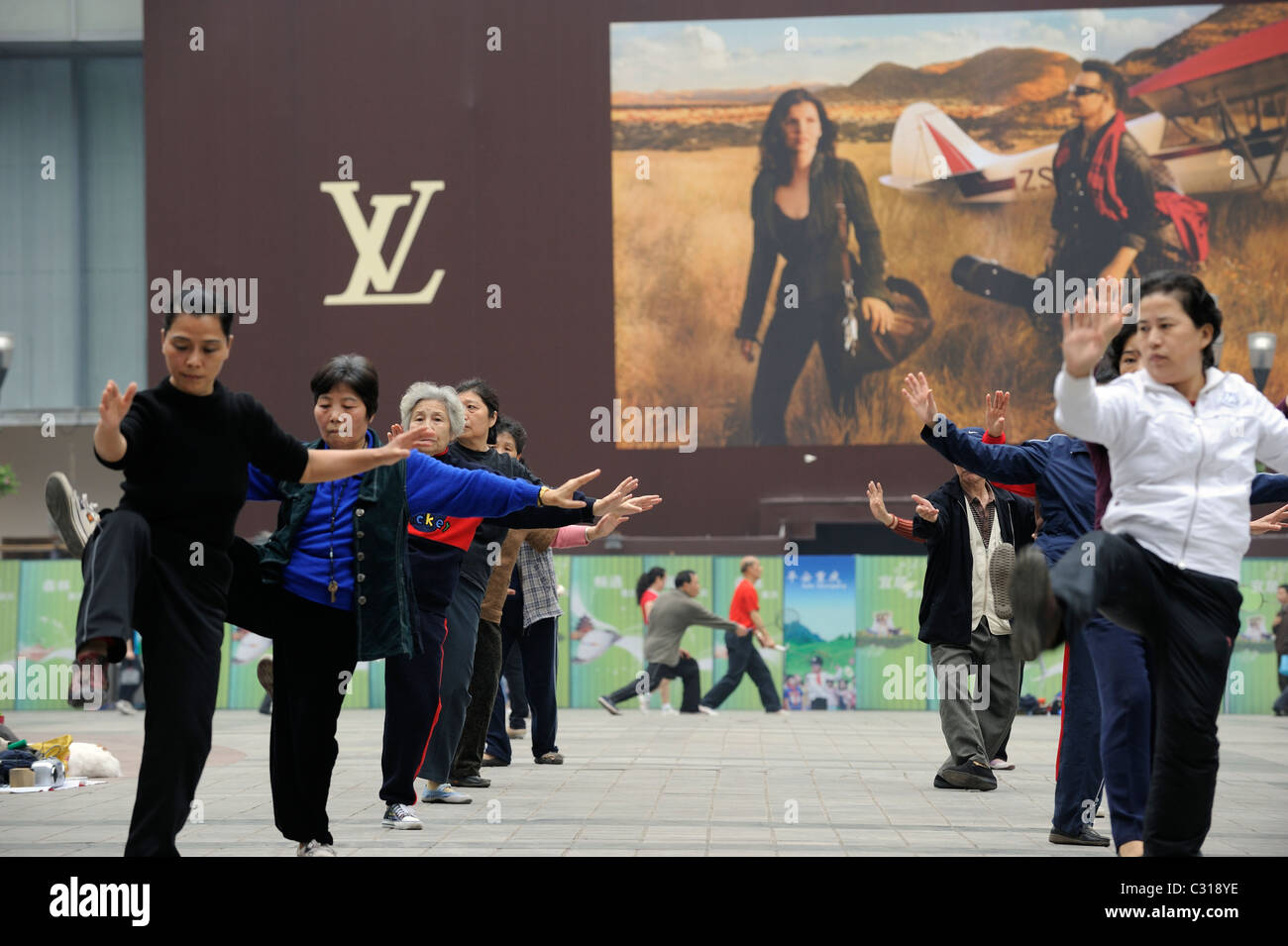 People morning excise in front of Louis Vuitton billboard in downtown  Chongqing, China. 22-Apr-2011 Stock Photo - Alamy