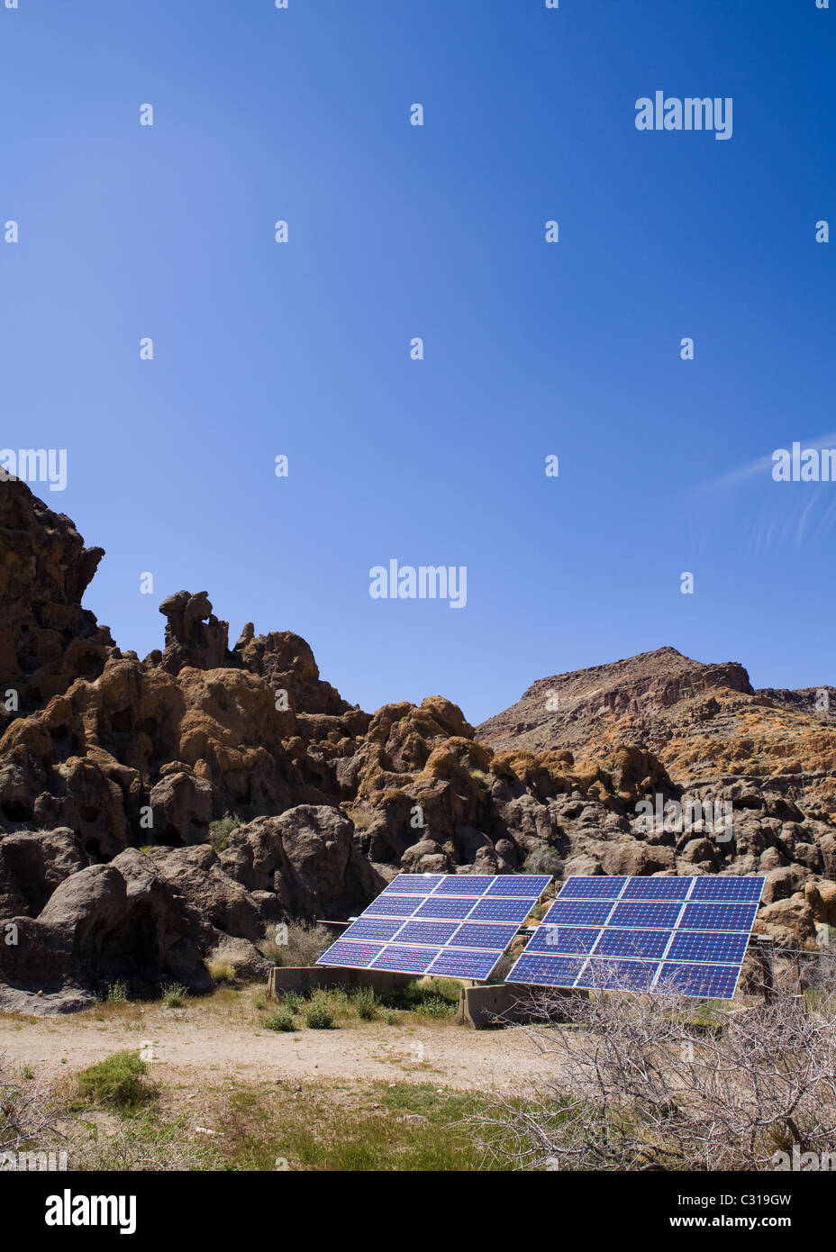 Solar panel against rocky landscape and blue sky - California USA Stock Photo