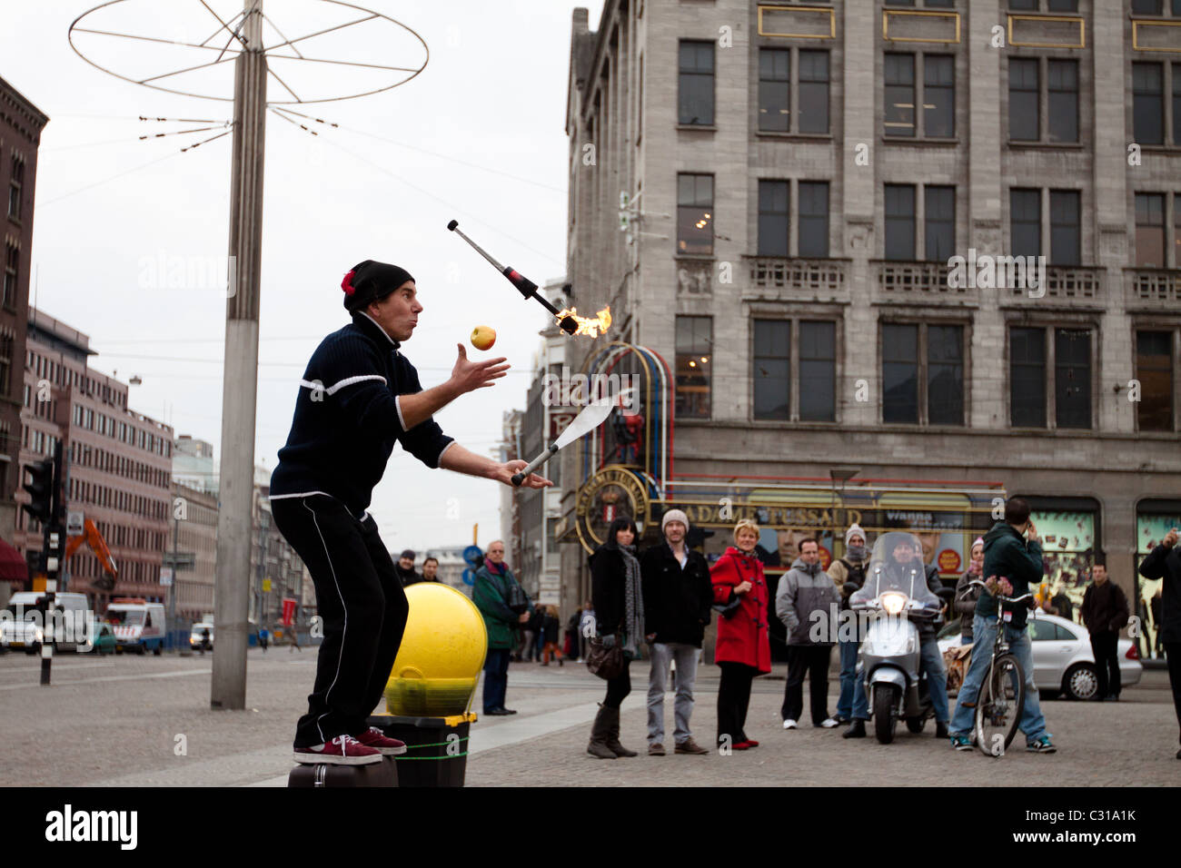 A Street Entertainer Does His Act For A Crowd Of Tourists Who Have 