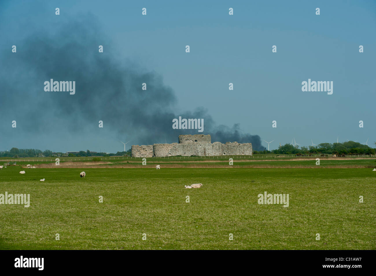 Smoke rises behind Camber Castle East Sussex England UK Stock Photo