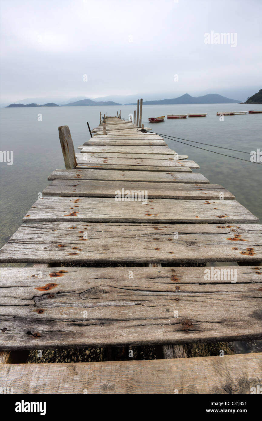 Looking over a desolate peer and a boat Stock Photo - Alamy