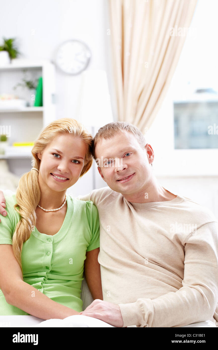 Amorous couple sitting on sofa hi-res stock photography and images - Alamy