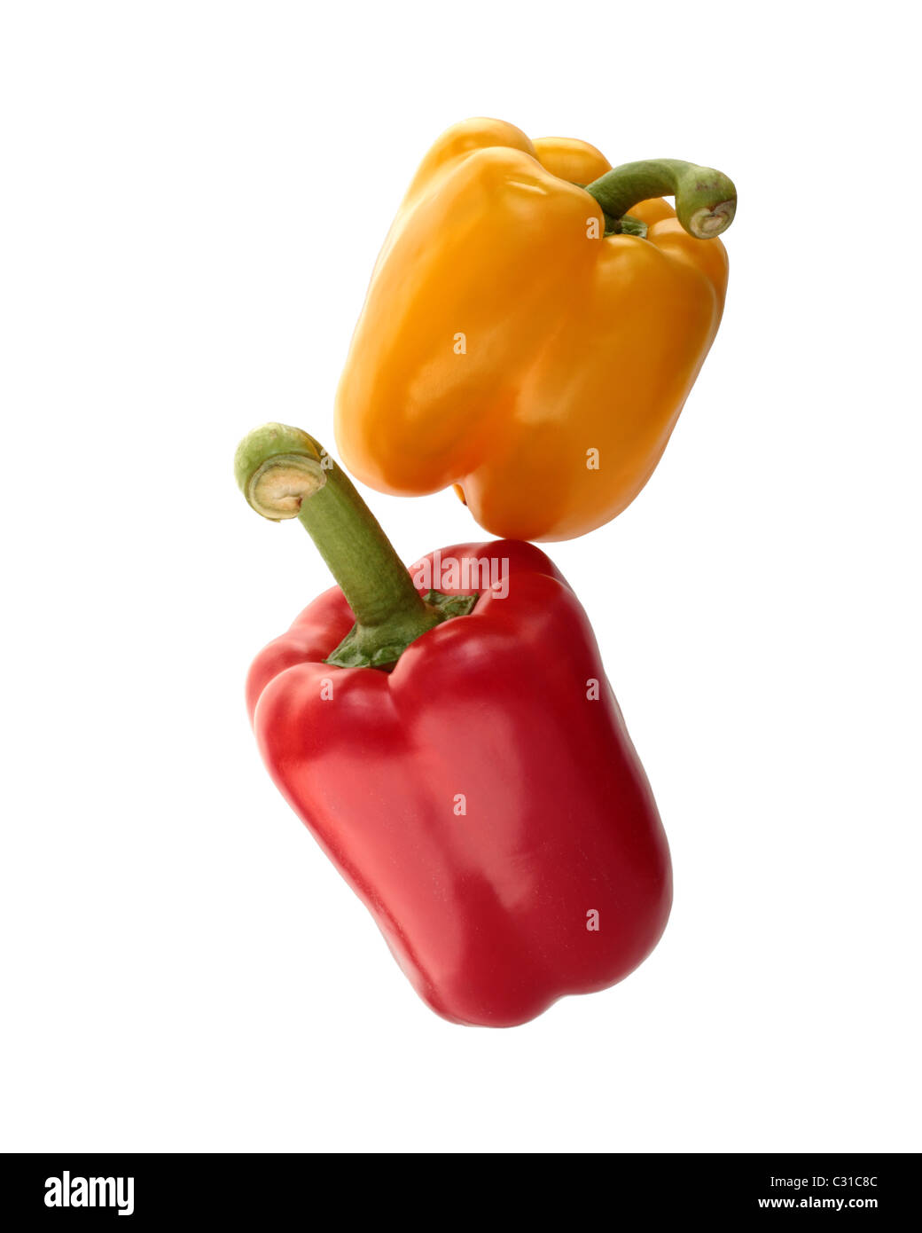 Yellow and red peppers stacked. Isolated on a white background. Stock Photo