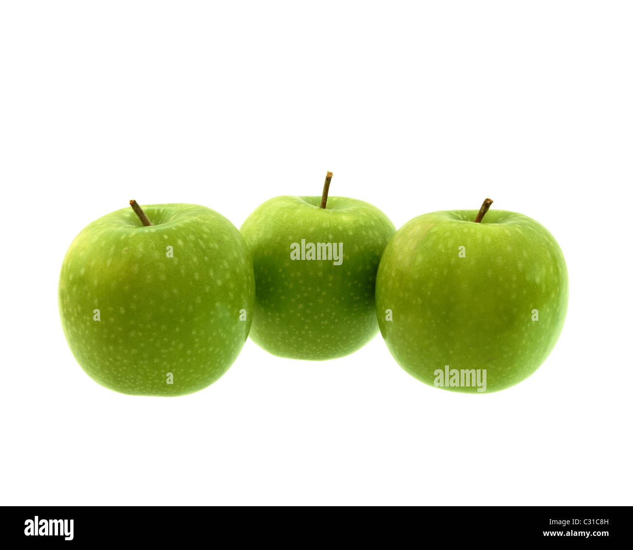Three green apples in a line isolated on a white background. Stock Photo