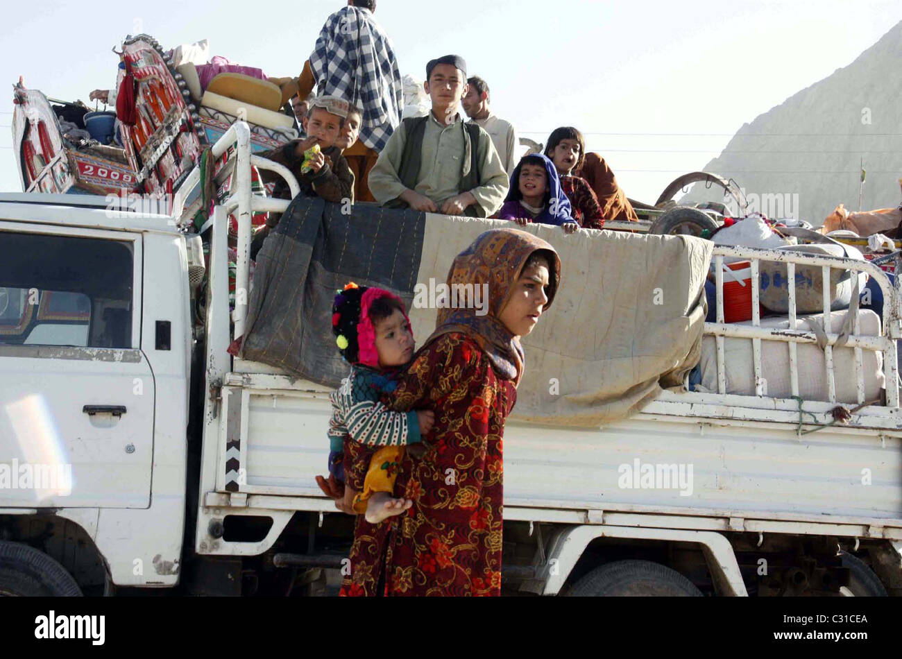 Afghan refugee children sit on a truck as they are waiting for leave to their homeland at a United Nation High Commissioner Stock Photo