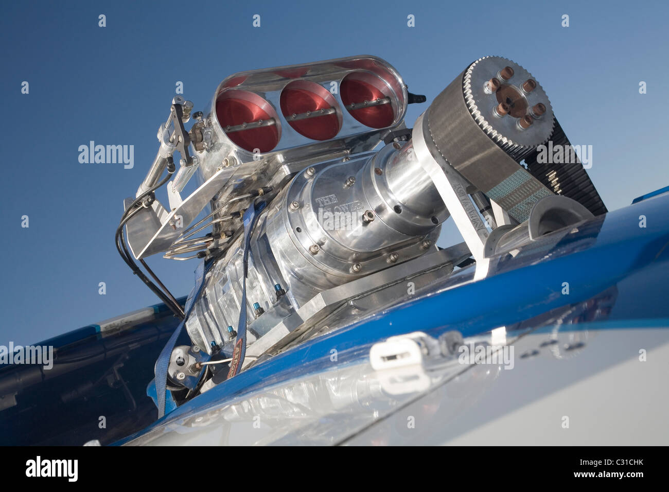 Belt driven supercharger with injection hat on the top of a powerful