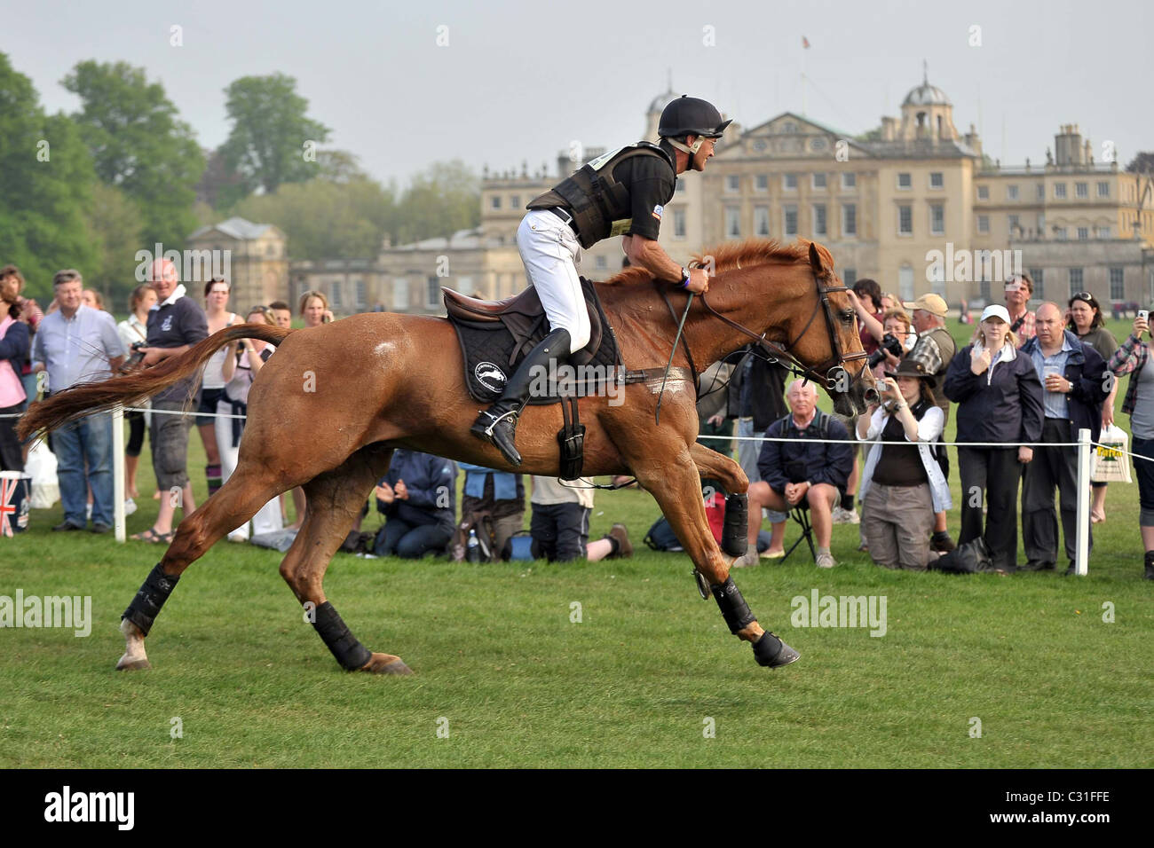 Andrew Nicholson (NZL) riding NEREO gallops with the house in the background. Mitsubishi Badminton Horse Trials Stock Photo